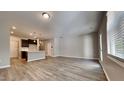 Open concept living room and kitchen area with hardwood flooring at 3635 Water Mist Ln, Raleigh, NC 27604