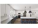 Modern kitchen with blue cabinets, white countertops, and an island at 914 Allen Park Dr, Raleigh, NC 27604