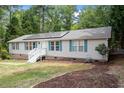 Single-story home with solar panels and landscaped yard at 1510 Logan St, Durham, NC 27704