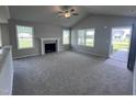 Spacious living room with vaulted ceiling, fireplace and carpet flooring at 78 Grace Ridge Ct, Benson, NC 27504