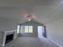 Living room with vaulted ceiling, fireplace and carpet flooring at 78 Grace Ridge Ct, Benson, NC 27504