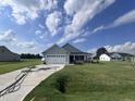 Two-car garage house with gray siding and landscaped lawn at 78 Grace Ridge Ct, Benson, NC 27504