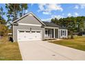 Gray house with white garage door and driveway at 150 Bennett Rd, Coats, NC 27521