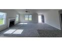 Spacious living room with fireplace, neutral carpet, and lots of natural light at 117 Grace Ridge Ct, Benson, NC 27504
