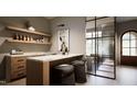 Modern wet bar with marble countertop and wooden cabinetry at 5428 Winding View Ln, Raleigh, NC 27615