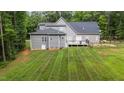 Spacious backyard with deck, fenced area, and lush lawn at 13671 Burgess Rd, Middlesex, NC 27557