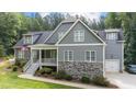 Gray two-story house with stone accents, attached garage, and large yard at 13671 Burgess Rd, Middlesex, NC 27557