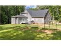 Spacious backyard with deck, fenced area, and lush lawn at 13671 Burgess Rd, Middlesex, NC 27557