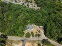 Aerial view showing house surrounded by trees at 3716 Pearl Rd, Raleigh, NC 27610