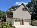 House exterior with two-car garage, stone foundation, and large windows at 901 Tanglewood Dr, Siler City, NC 27344