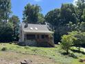 House exterior showcasing stonework, a wraparound porch, and lush landscaping at 901 Tanglewood Dr, Siler City, NC 27344