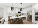 Modern kitchen features stainless steel appliances and an island with seating at 320 Church St # 3, Morrisville, NC 27560