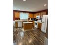 Kitchen with island and wood cabinets at 506 Averasboro Dr, Clayton, NC 27520