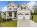 Beautiful two-story house with stone accents and landscaping at 816 Willow Tower Ct # 154, Rolesville, NC 27571