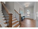 Modern staircase with dark wood railings and white risers at 816 Willow Tower Ct # 154, Rolesville, NC 27571
