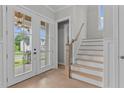 Bright entryway with double doors, hardwood floors, and elegant staircase at 812 Willow Tower Ct # 155, Rolesville, NC 27571