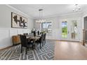 Elegant dining room features a large table, chandelier, and hardwood floors at 812 Willow Tower Ct # 155, Rolesville, NC 27571