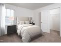Bright bedroom with striped bedding and closet at 940 Rift Valley Dr, Zebulon, NC 27597