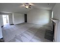 Spacious living room with vaulted ceiling, fireplace, and carpeted floors at 31 Grace Ridge Ct, Benson, NC 27504