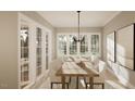Bright dining room features a large wooden table, six chairs, and access to a porch at 5628 Bella Terra Ct, Wake Forest, NC 27587