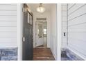 Front entry featuring a gray door and wood-look floors at 8820 Melvin St # 16, Willow Springs, NC 27592