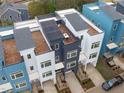 Aerial view of modern townhouses with rooftop decks and city skyline in the background at 614 Rocky Knob Ct, Raleigh, NC 27601