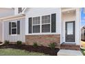 Craftsman style home with gray siding, brick accents, and a welcoming front porch at 795 Washington St, Fuquay Varina, NC 27526