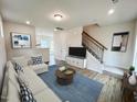 Bright living room with hardwood floors, neutral colors, and a cozy seating area at 141 Courtside Dr, Dunn, NC 28334