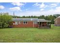 Brick house with a large backyard, deck, and shed at 560 Wayview Rd, Henderson, NC 27537