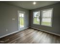 Spare bedroom with wood-look flooring and access to the backyard at 46 Scotties Ridge Dr, Princeton, NC 27569