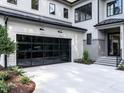 Attached garage with modern glass-panel door at 2104 Manuel St, Raleigh, NC 27612