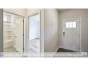 Bright entry hall with wood-look floors, leading to bathroom and additional rooms at 1677 Abberly Pl, Graham, NC 27253