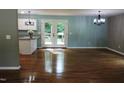 Open dining room with hardwood floors and access to the kitchen at 513 N Carr St, Mebane, NC 27302