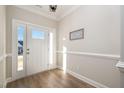 Bright and airy entryway with hardwood floors and a welcoming sign at 35 Uptown Rd, Zebulon, NC 27597