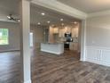 Modern kitchen with island, stainless steel appliances, and hardwood floors at 90 Watermelon Dr, Franklinton, NC 27525