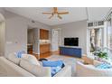 Living room with hardwood floors, ceiling fan, and built-in entertainment center at 3201 Environ Way # Bldg 3000, Chapel Hill, NC 27517