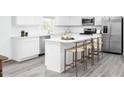 Modern kitchen with white cabinets, island, and stainless steel appliances at 278 Gianna Dr, Lillington, NC 27546
