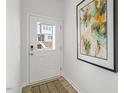 Bright entryway with a white door and modern artwork at 723 Dorset Stream Dr, Fuquay Varina, NC 27526