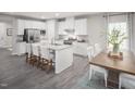 Modern kitchen with island, stainless steel appliances, and hardwood floors at 8916 Stratus St, Willow Springs, NC 27592
