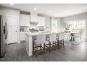 Modern kitchen with island, stainless steel appliances, and hardwood floors at 8916 Stratus St, Willow Springs, NC 27592