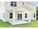 Covered patio with columns, concrete flooring and sliding glass doors at 8916 Stratus St, Willow Springs, NC 27592