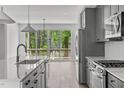 Modern kitchen features stainless steel appliances and access to a deck at 6408 Tanner Oak Ln, Raleigh, NC 27613