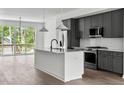 Modern kitchen with stainless steel appliances and a large island at 6408 Tanner Oak Ln, Raleigh, NC 27613