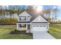 Two-story home with gray siding, white trim, and landscaping at 110 Merrifield Ln, Garner, NC 27529