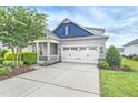 Two-story house with gray and blue siding, white garage door, and landscaping at 258 Tyree Trl, Burlington, NC 27215