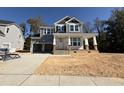 New construction home with gray siding, two-car garage, and porch at 409 Jones Bluff Way, Knightdale, NC 27545