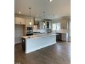 Modern kitchen with large island and stainless steel appliances at 317 Kavanaugh Rd, Wake Forest, NC 27587