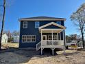 Two-story home with a deck and covered porch at 196 Grand Griffon Way, Lillington, NC 27546