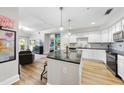 Open concept kitchen with granite island and stainless steel appliances at 222 Glenwood Ave # 307, Raleigh, NC 27603