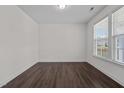 Simple office space with hardwood floors and large window at 135 Glenfield Ln, Burlington, NC 27215
